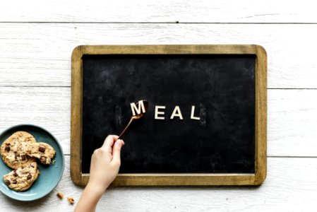 Person Holding Black And Brown Food Tray photo