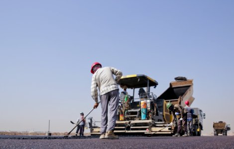 Group Of Men Repairing A Road