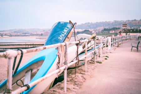 Photo Of White And Blue Boats Beside White Railings photo