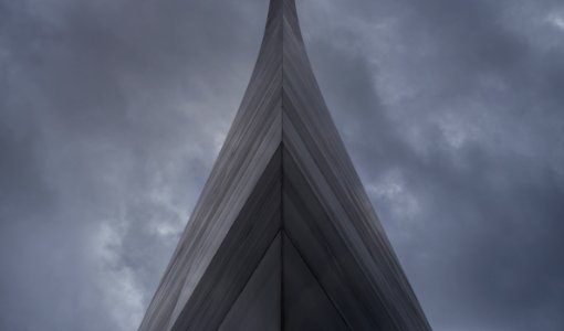 Gray Building Under Dark Clouds photo