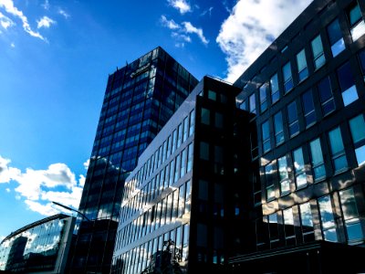 Low-angle Photography Of Curtain Wall Building Taken Under White Clouds And Blue Sky photo