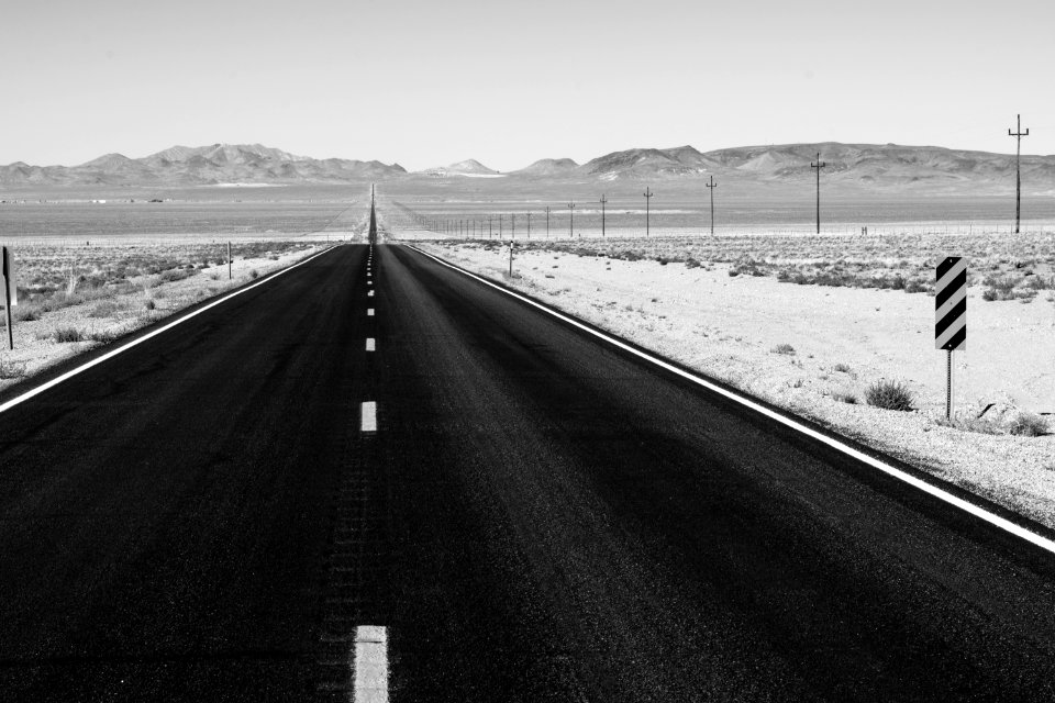 Grayscale Photo Of Road On Desert photo