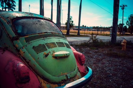 Photography Of Green And Pink Volkswagen Beetle Parked Beside The Road