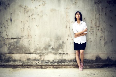 Woman Standing Next To A Wall photo