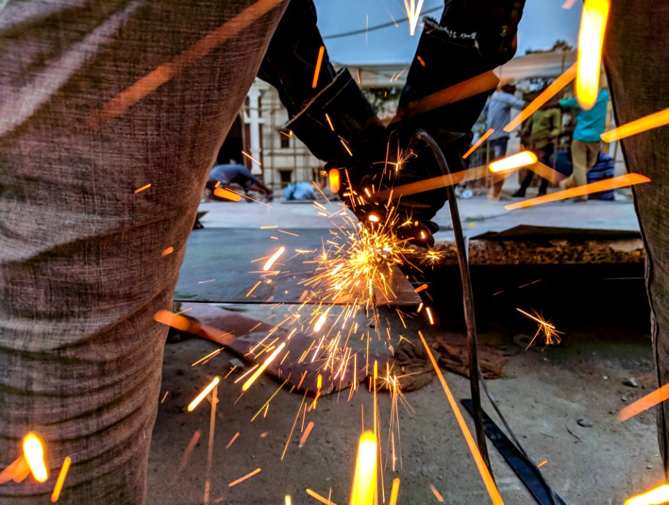 Man Cutting Steel Using A Power Tool