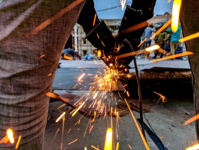 Man Cutting Steel Using A Power Tool