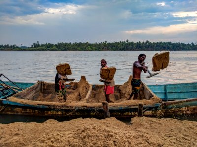 Three Person Standing On Blue Boat photo