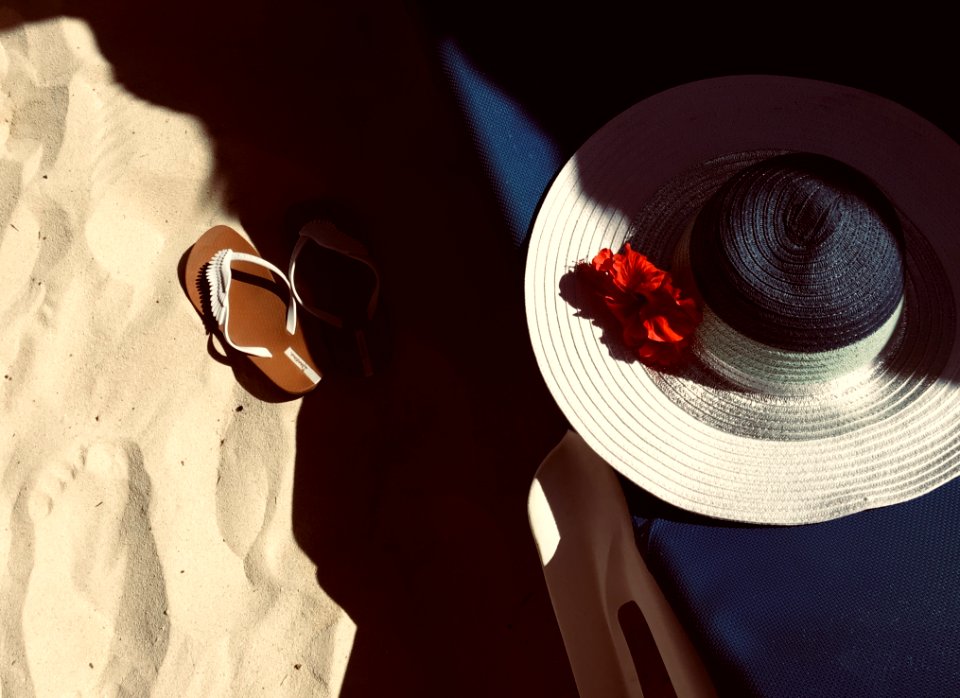 White And Black Hat On Blue Surface