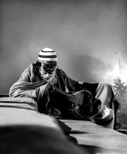 Grayscale Photo Of Man With Taqiyah Cap photo