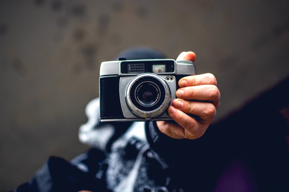 Person Holding Gray And Black Slr Camera