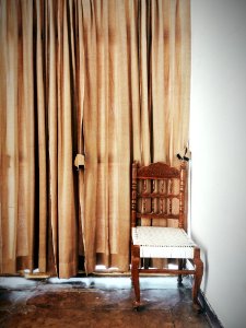 Brown And White Wooden Chair Beside A Brown Window Curtain photo