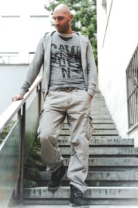 Photo Of Man Wearing Grey Zip-up Jacket And Brown Cargo Pants Walking Down On Concrete Stairs photo