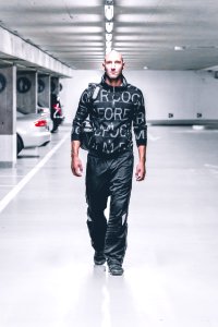 Photo Of Man In Black Pants And Top Walking In Parking Lot
