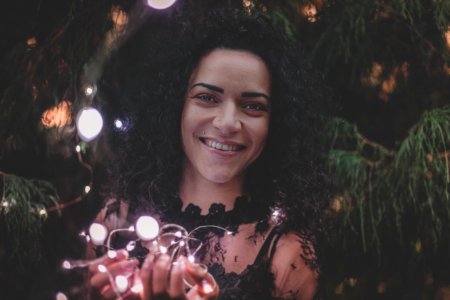 Close-U Photography Of A Woman Holding String Lights photo