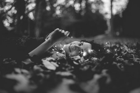 Grayscale Photo Of Person Lying On Ground photo