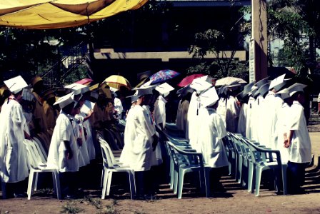 Children Wearing White Academic Gown During Graduation Ceremony At Daytime
