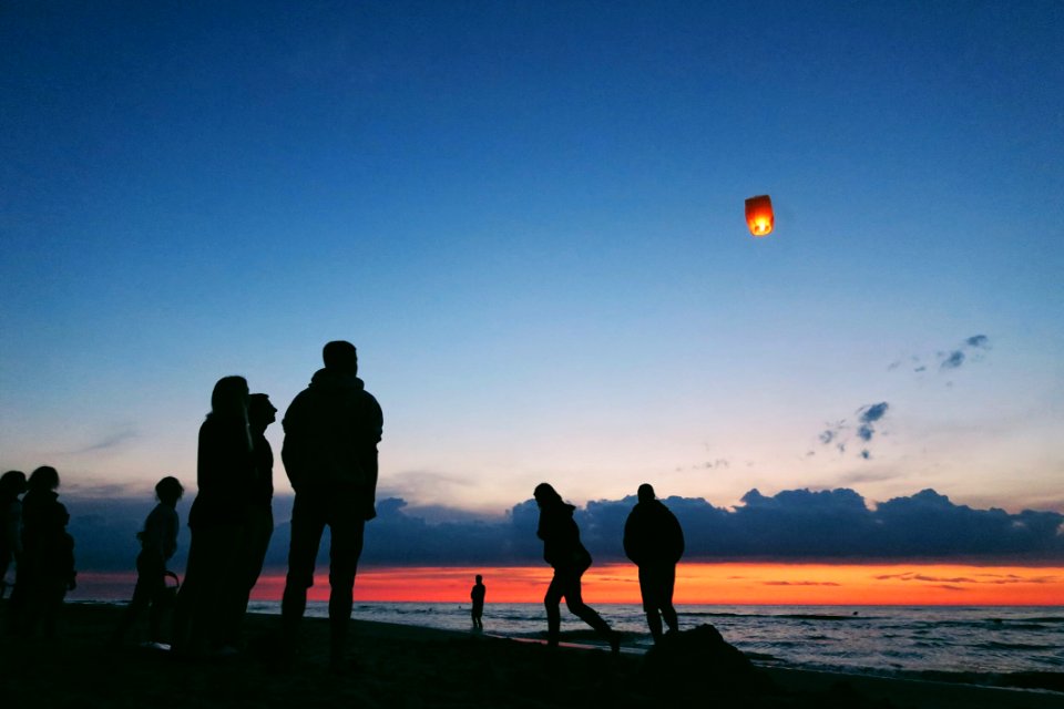Silhouette Of People By The Sea