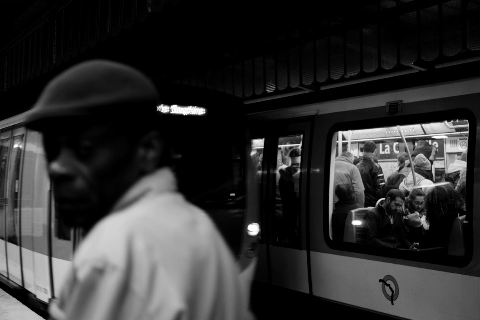 Grayscale Photo Of People Inside Train photo