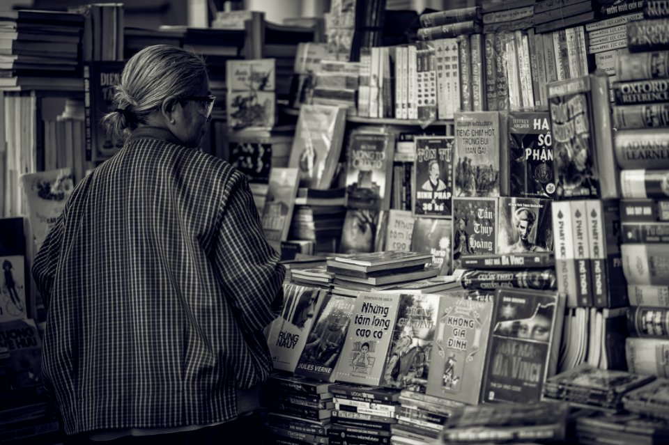 Grayscale Photography Of Woman Looking At The Books