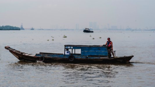 Photo Of Man On Wooden Boat photo