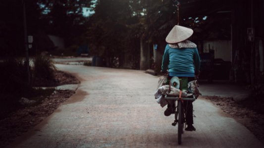 Person In Blue Long-sleeves Riding Bicycle photo