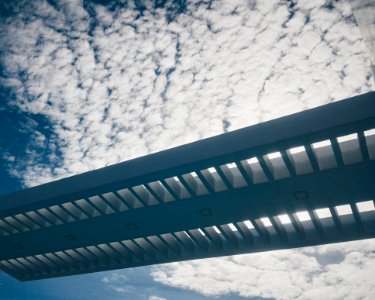 Silhouette Of Bridge Under Cloudy Sky photo