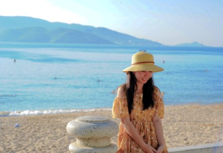 Woman Wearing Brown Off-shoulder Dress Near Ocean Water photo