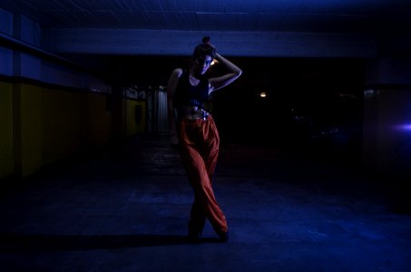 Woman Wearing Black Crop-top And Orange Pants Inside Parking Lot photo