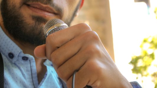 Close-up Photo Of Man Holding Microphone photo