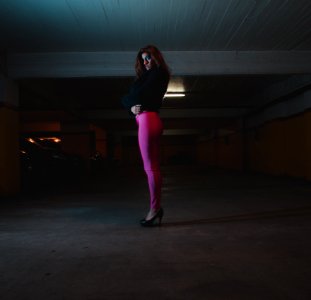 Photo Of Woman Wearing Black Shirt And Pink Leggings In Parking Area photo