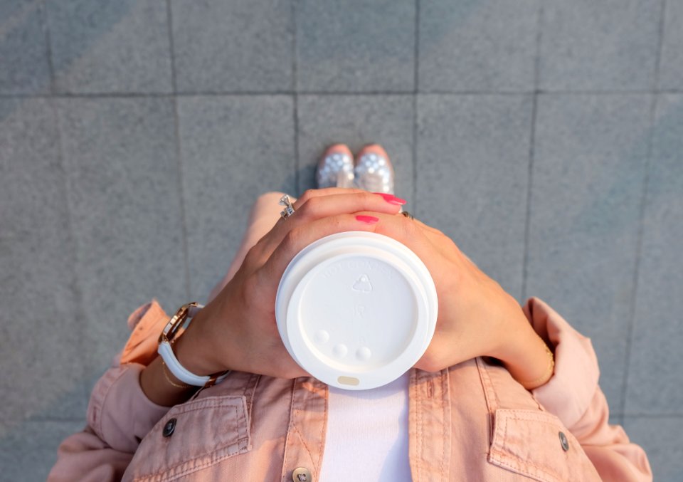 Person Holding White Disposable Cup