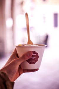 Selective Focus Photography Of Person Holding Vacenza Labeled Cup photo