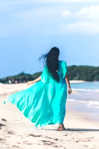 Woman Wearing Teal Dress While Walking Near Body Of Water photo