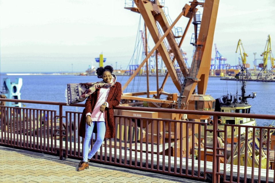 Woman Wearing Red Coat And Blue-washed Jeans