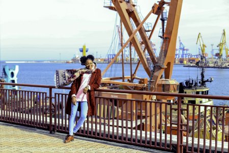 Woman Wearing Red Coat And Blue-washed Jeans photo