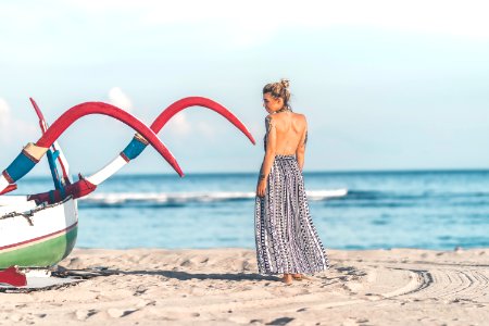 Photo Of Woman Standing On Seashore photo