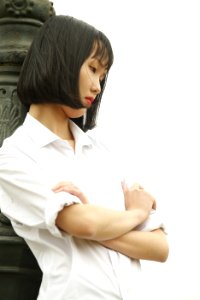 Woman Wearing White Dress Shirt Standing Near Concrete Statue