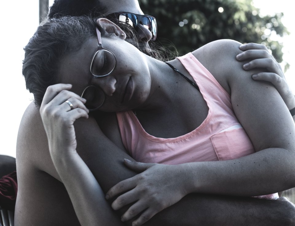 Man Embracing Woman Wearing Pink Tank Top