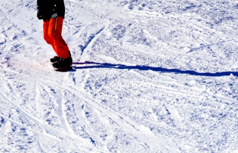 Photo Of Person Wearing Black Top And Orange Pants Riding Snowboard