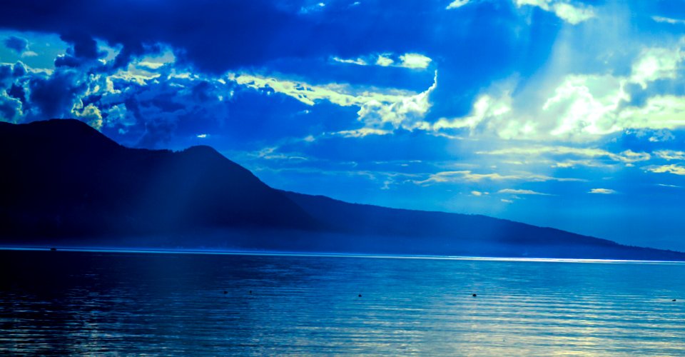 Silhouette Of Mountain Near Water At Daytime photo