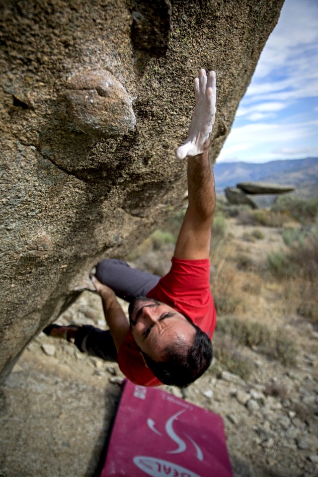 Man Climbing On Gray Concrete Peak At Daytime