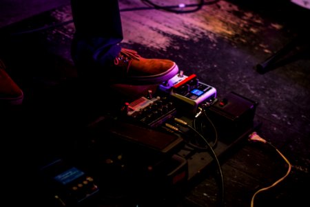 Person Operating Guitar Effects Pedal photo