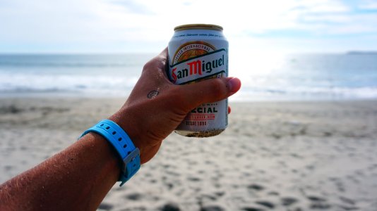 Person Holding San Miguel Beer Tin Can photo