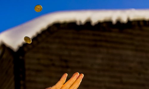 Shallow Focus Photography Of Person Catching Two Gold-colored Coins photo