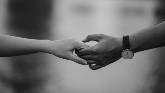 Monochrome Photo Of Couple Holding Hands photo