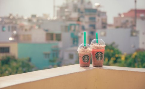 Close-Up Photography Of Two Starbucks Disposable Cups photo