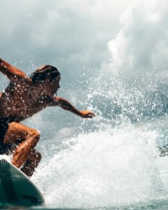 Man Riding White Surfboard photo