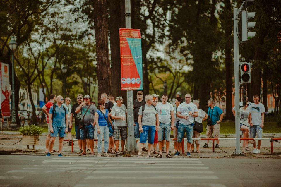 People Standing Near Metal Traffic Post