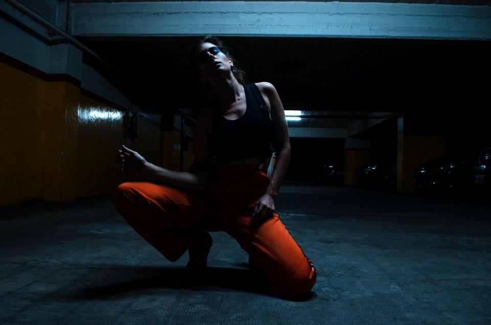 Woman Wearing Tank Top And Kneeling On The Floor