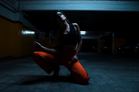 Woman Wearing Tank Top And Kneeling On The Floor photo